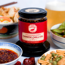 Load image into Gallery viewer, Jar of Chinese Chilli Oil on a table with snacks and drinks